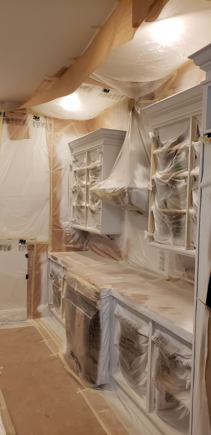 Butler's pantry cabinetry sheeted from ceiling to floor before spraying