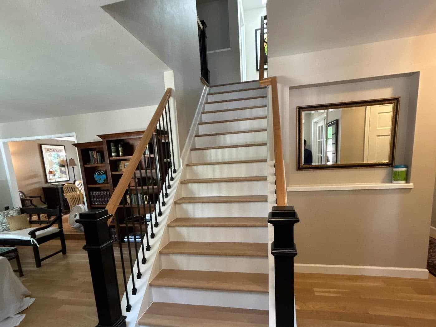 Finished stairwell with black newel posts and white risers