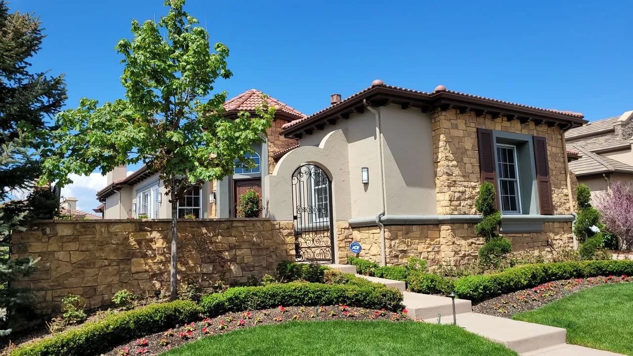 Mediterranean-style home with smooth painted eaves and stucco