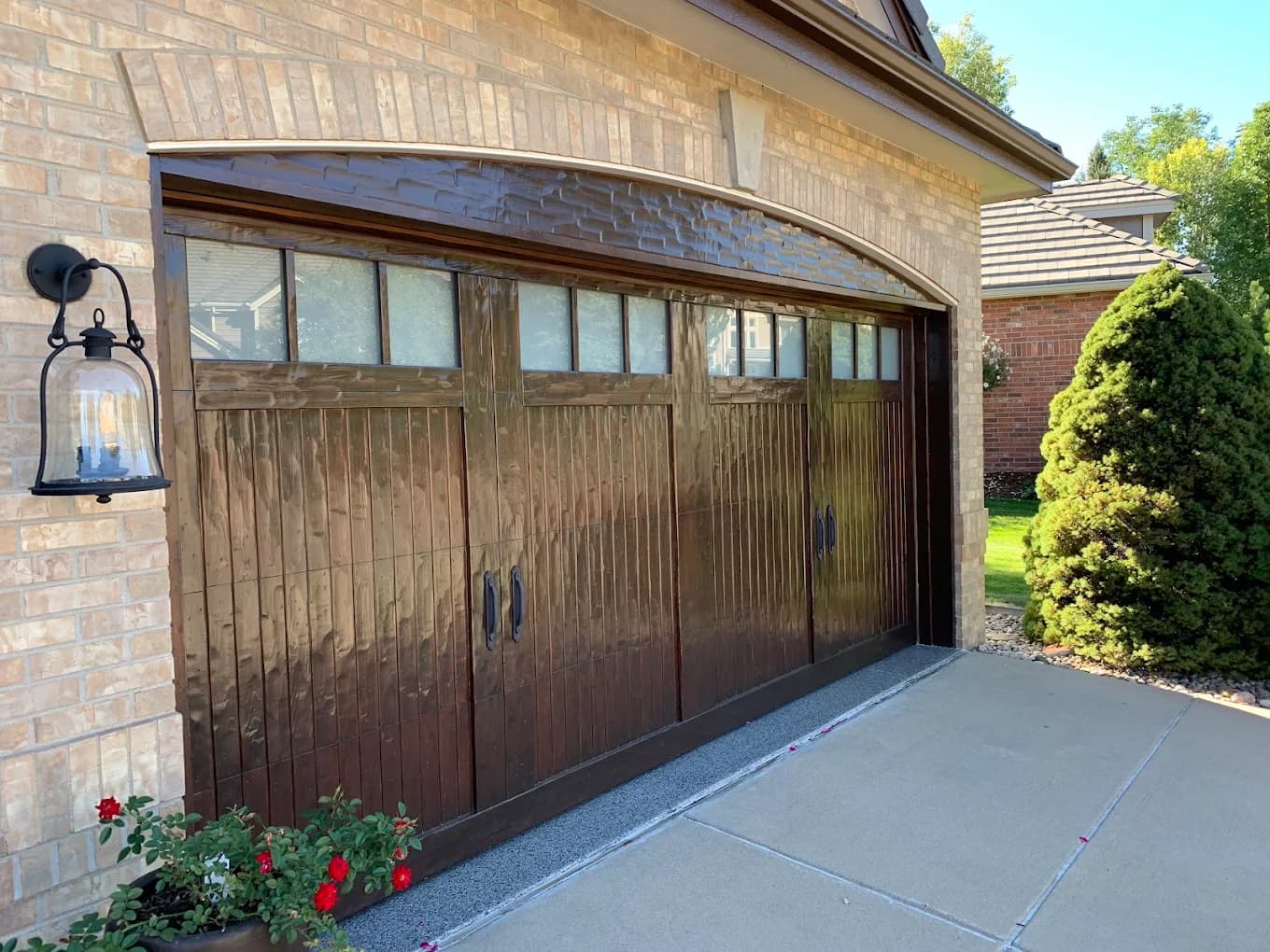 Timber garage door refinished in a deep walnut tone