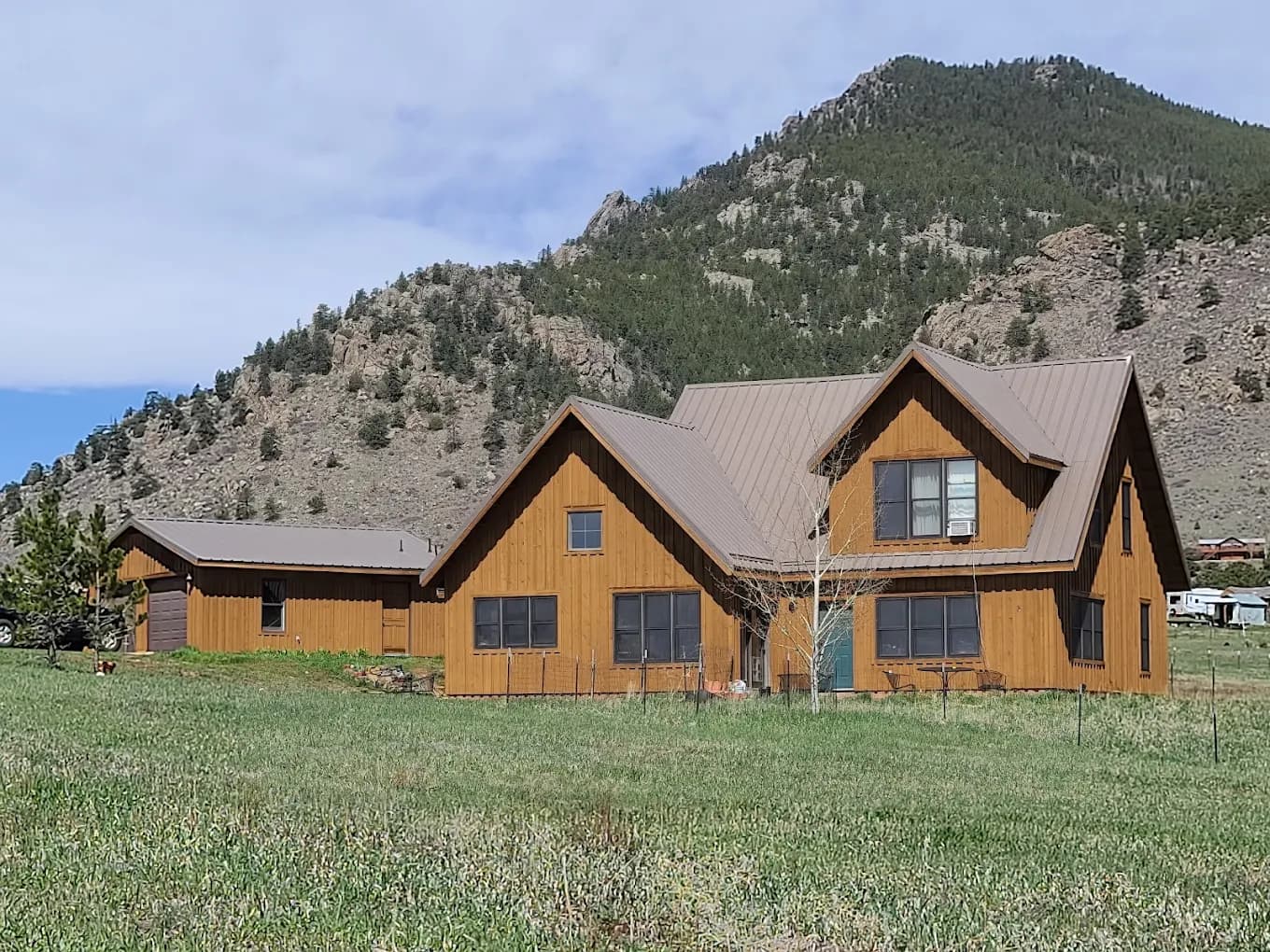Mountain lodge home with timber gables against the foothills