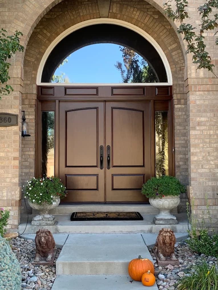 Arched brick entry with double timber doors