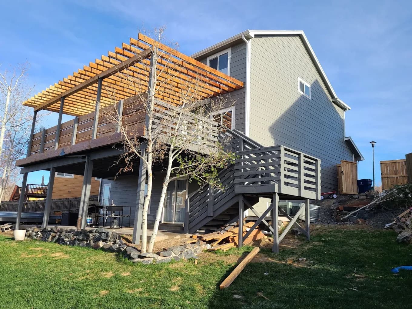 Raised deck and pergola framing on a hillside home