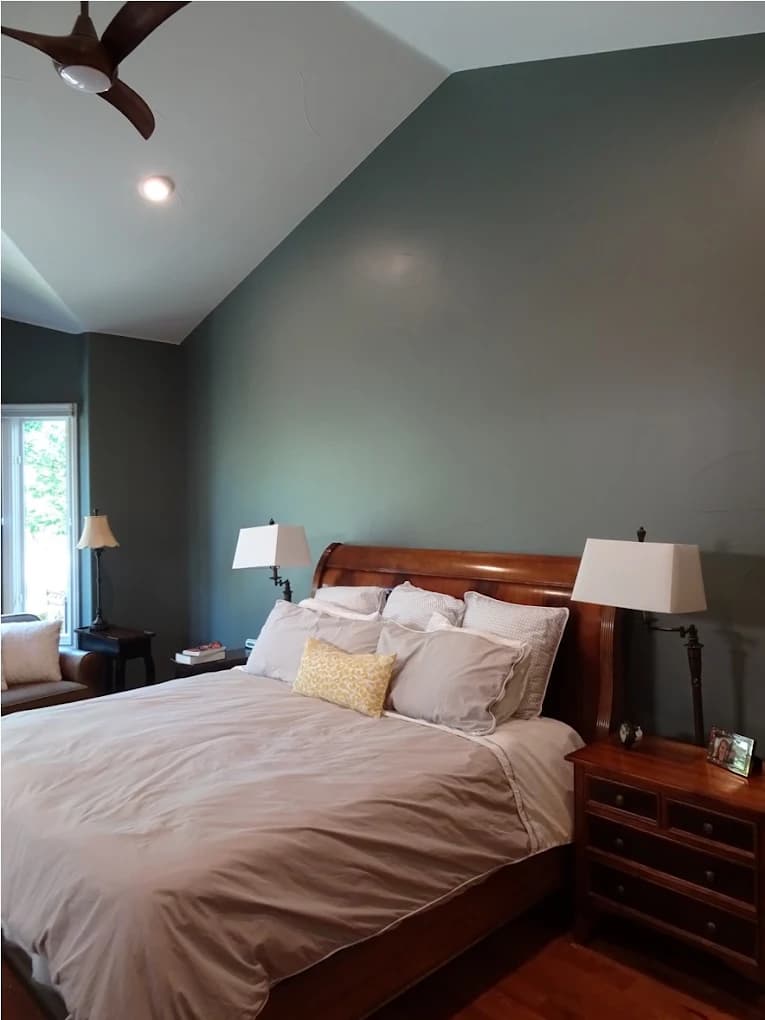 Bedroom repainted in a soft sage with white trim