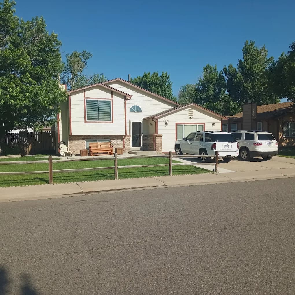 Ranch home with fresh siding and trim seen from the street