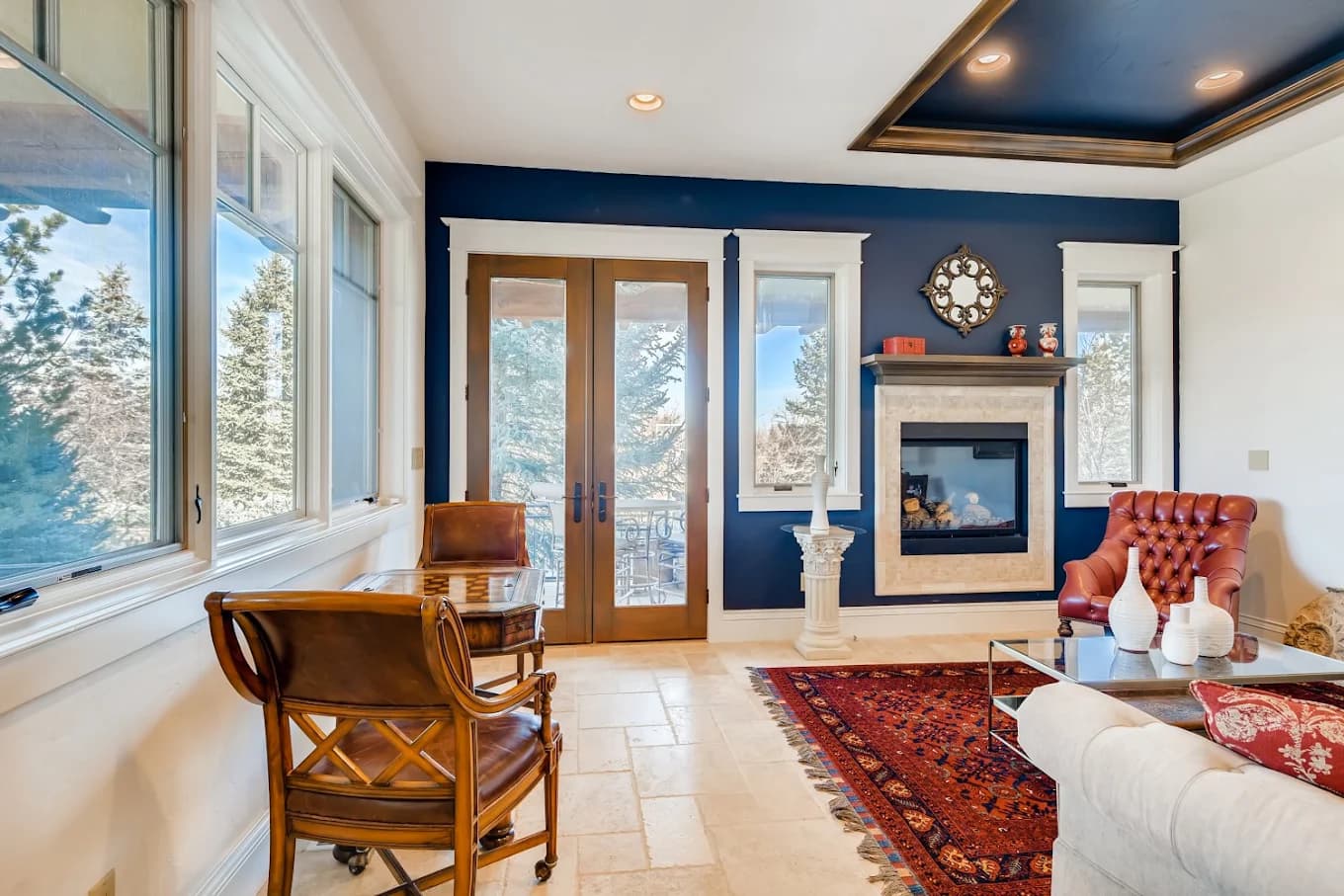 Sitting room with a navy accent wall and a painted tray ceiling