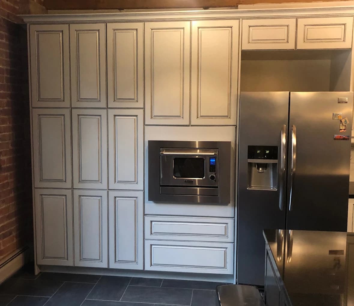 Cream raised-panel cabinetry around a built-in fridge