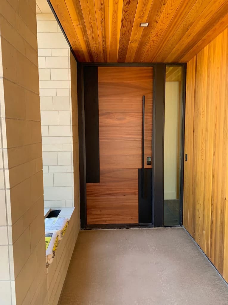 Cedar-clad entry porch around a timber front door