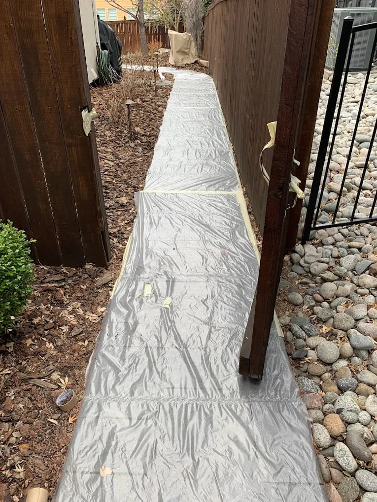 Exterior walkway covered before painting begins