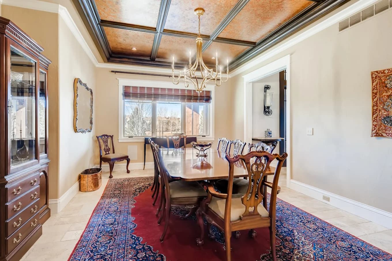 Formal dining room with a coffered ceiling and painted beams