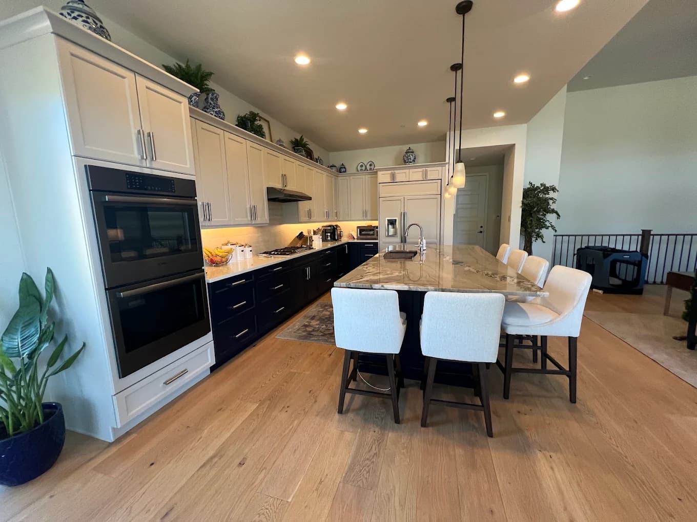 Navy and white kitchen with an island and bar chairs