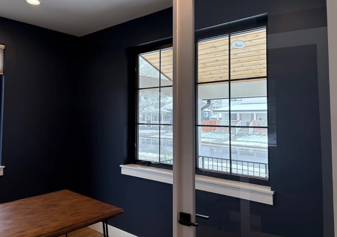 Navy accent wall beneath a smooth white ceiling