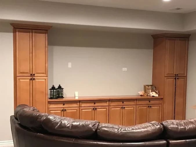 Basement built-in cabinetry in orange-toned oak