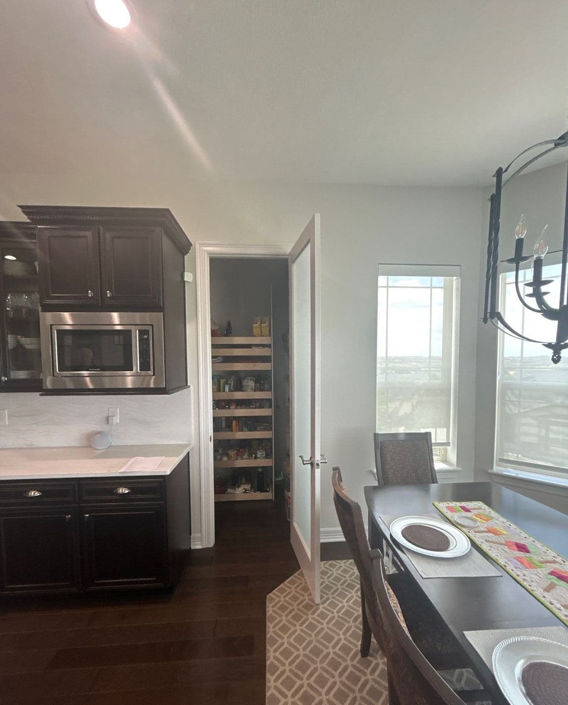 Dark painted kitchen cabinets with a stone countertop