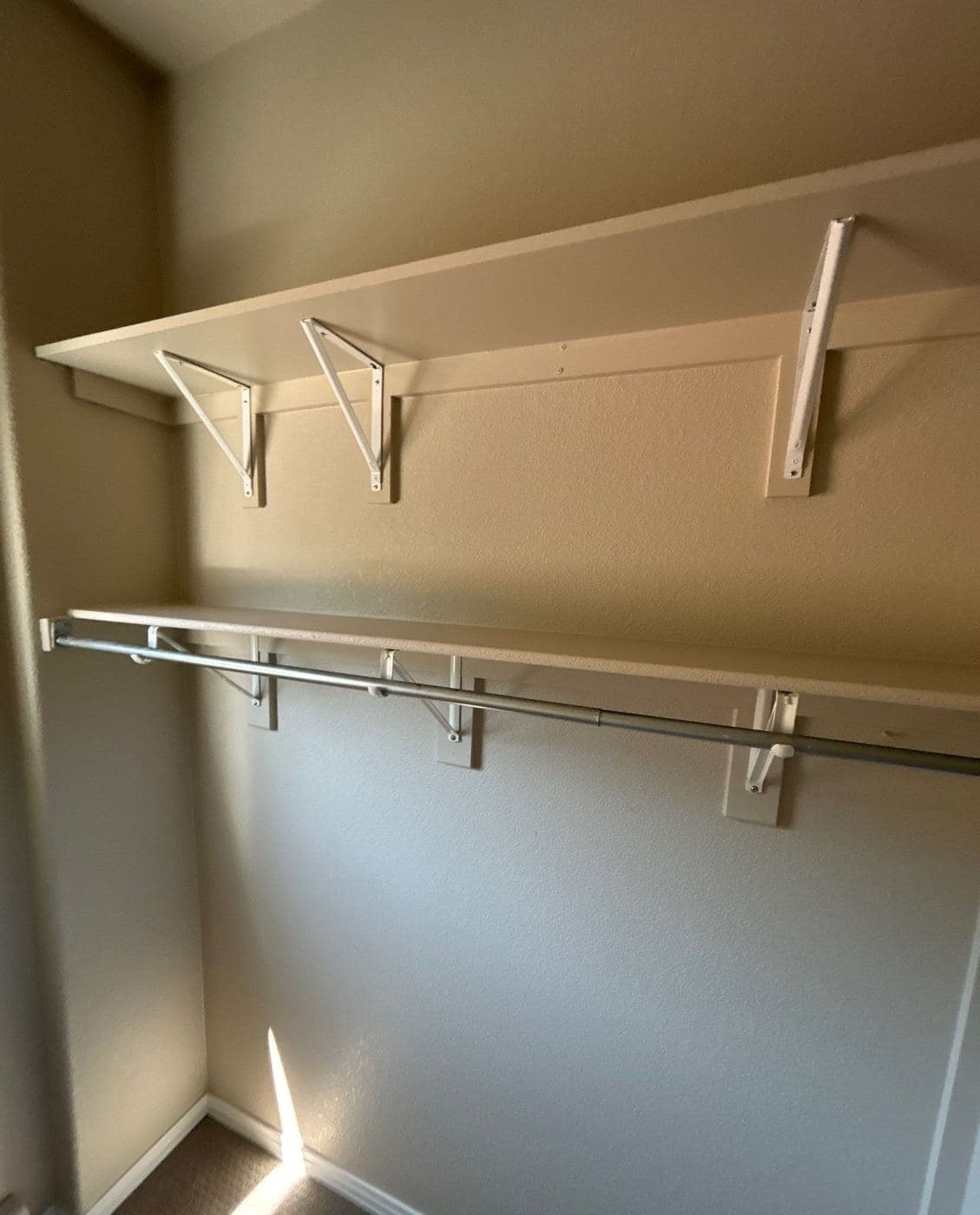 Painted closet shelving and hanging rails