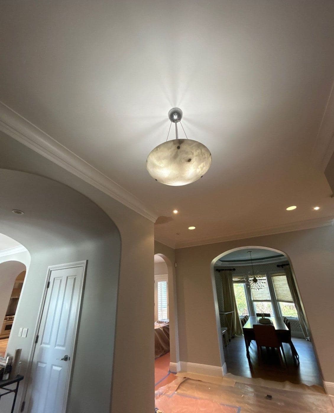 Smooth ceiling and crown molding above a repainted hallway