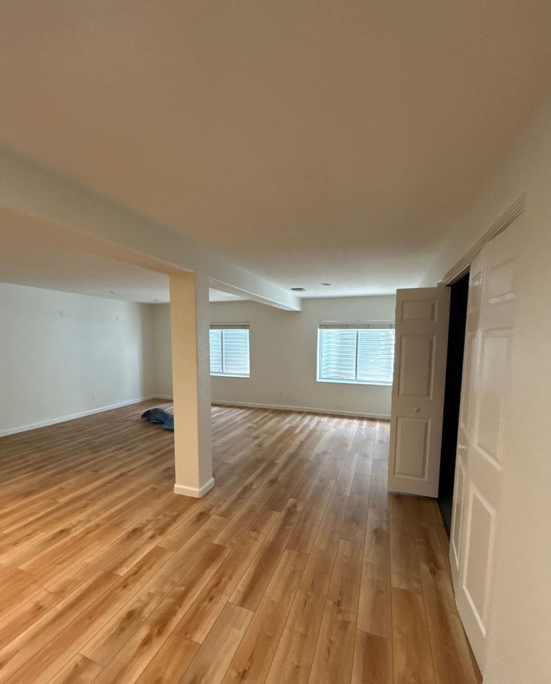Lower-level room with a smooth ceiling and repainted walls