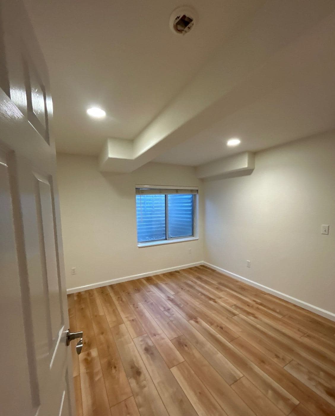 Bedroom with a smooth flat ceiling and fresh wall color