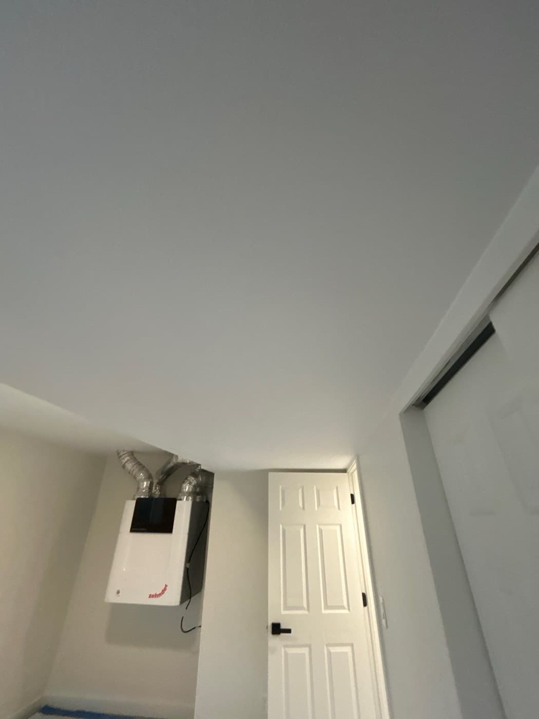 Flat white ceiling running the length of a finished room