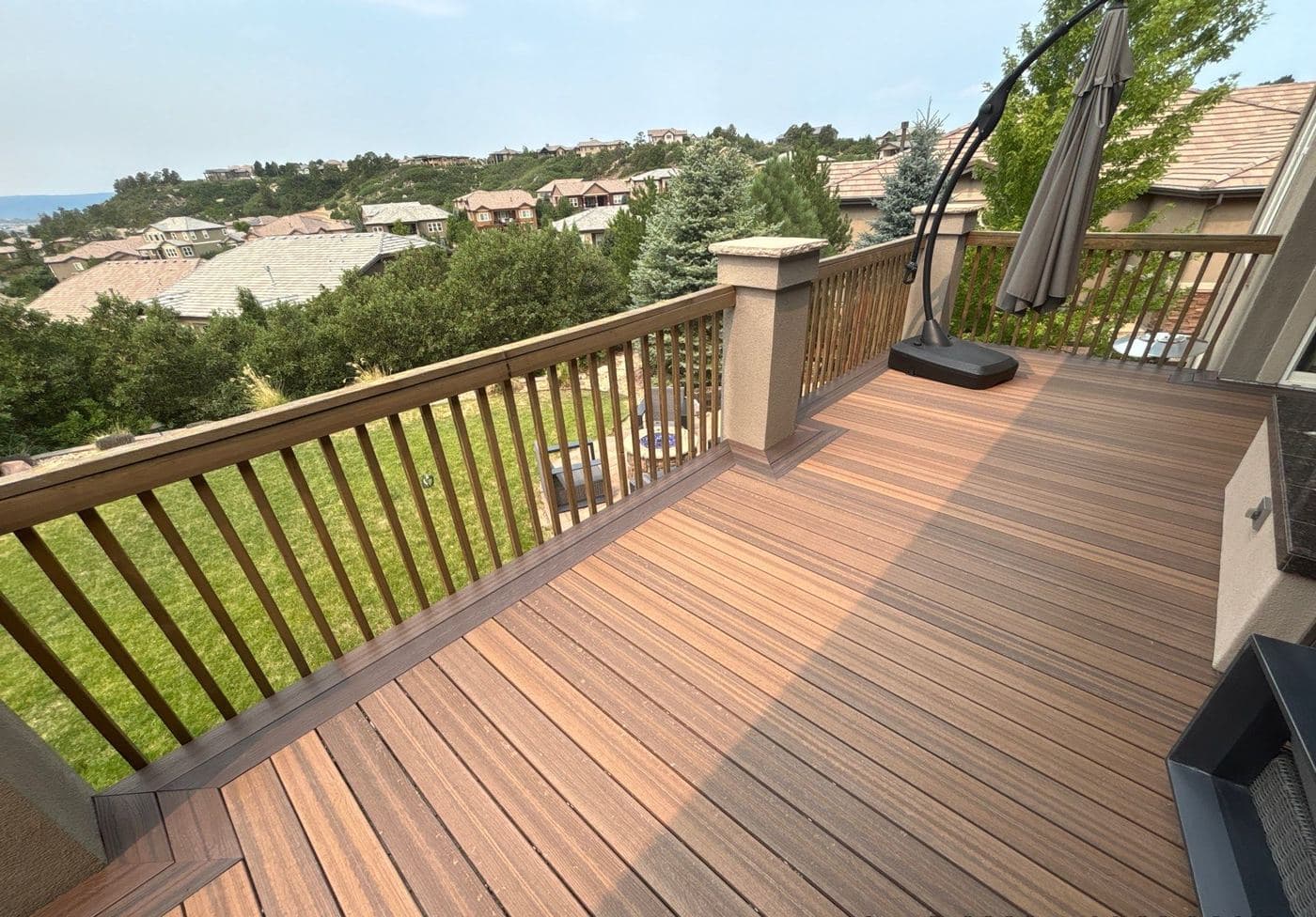 Freshly stained rear deck looking out over a Denver metro hillside