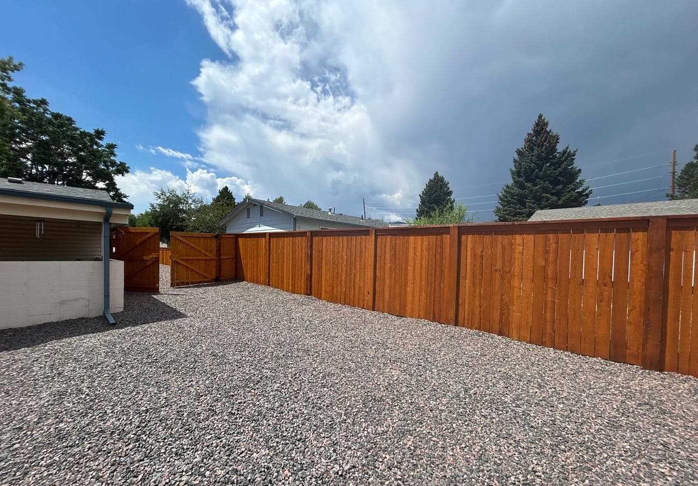 Privacy fence and gates freshly stained a warm cedar tone