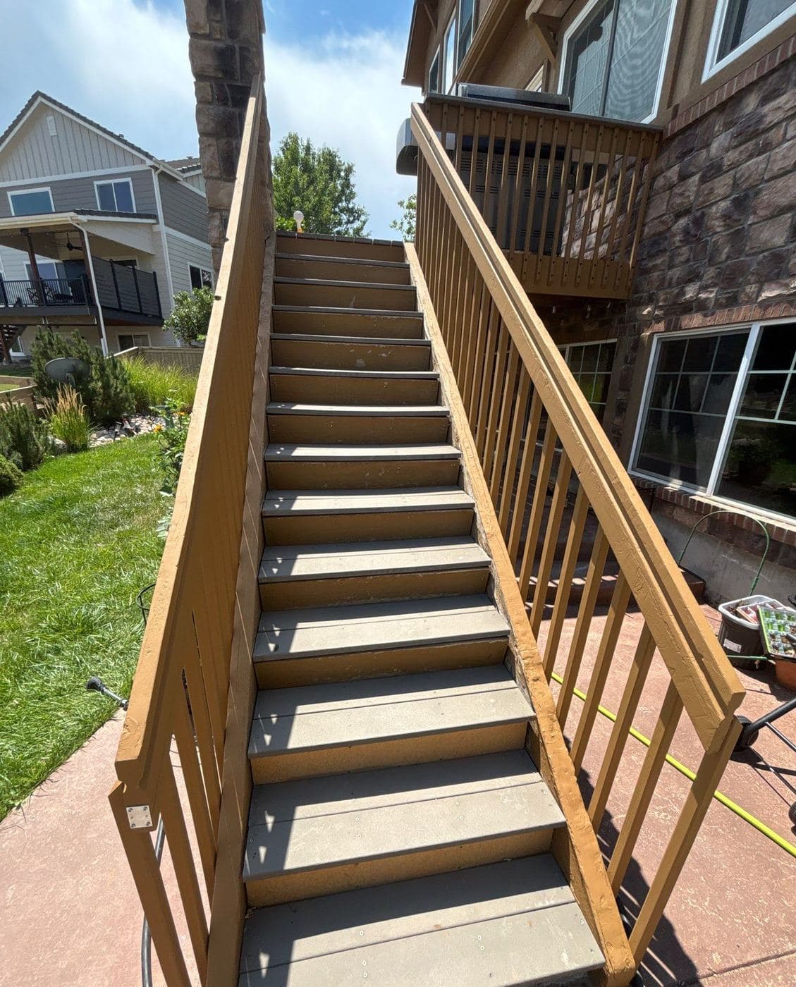 Deck staircase and railings finished in a warm stain