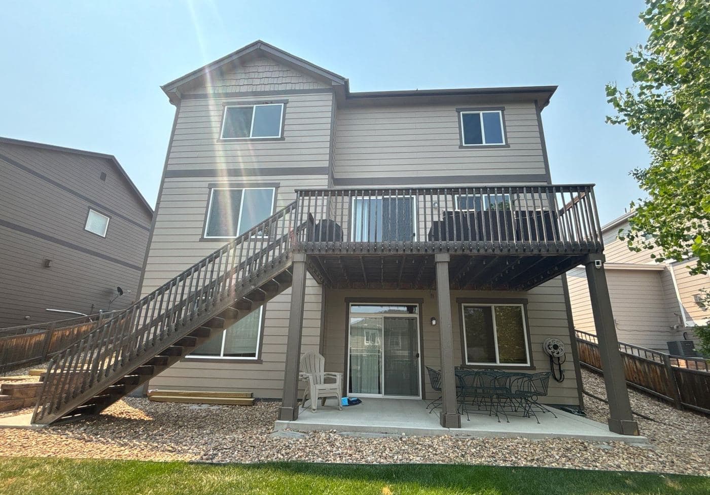 Two-story home with a raised deck and painted staircase
