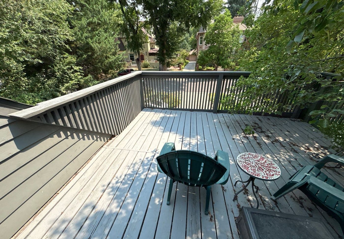 Gray deck with a fire pit and patio table