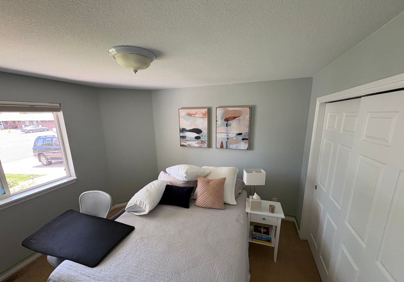Guest bedroom repainted in soft gray with white trim