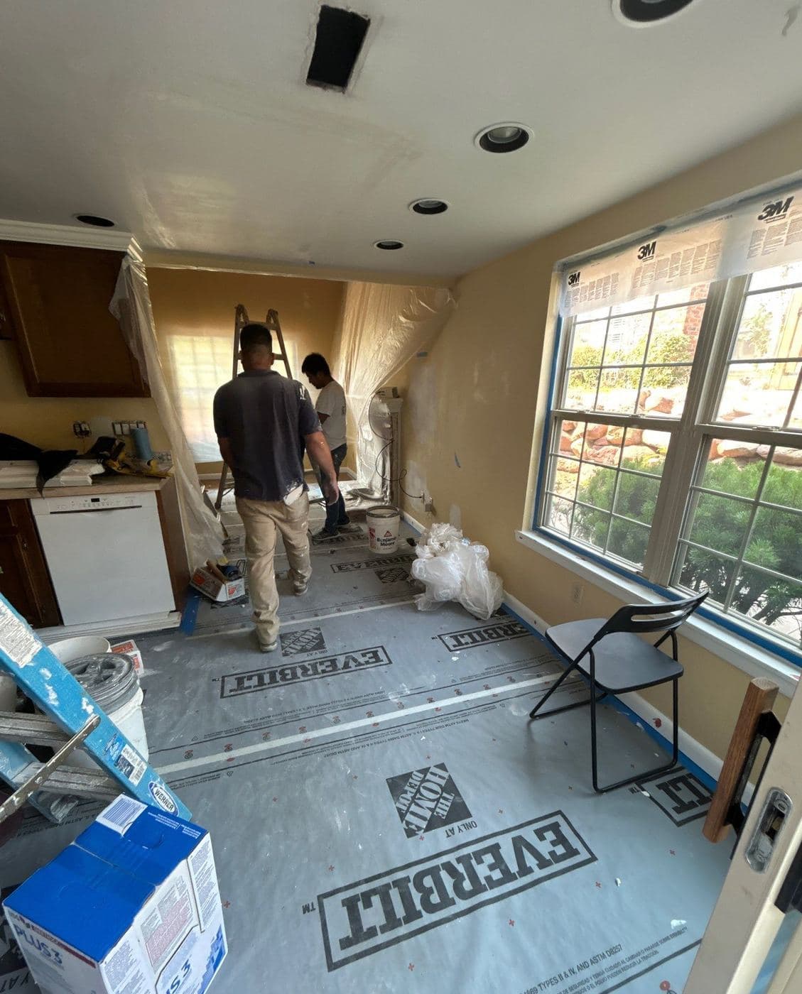 Helix crew painting a kitchen with the floor fully masked